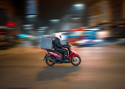 Food delivery driver on moped Food delivery driver on moped